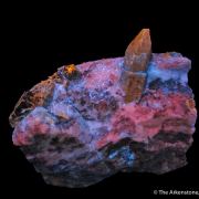 Afghanite (TL) (fl) on Calcite (fl)